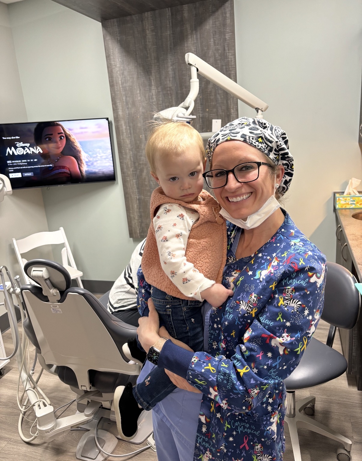Child watching a show during a dental visit at First Smile